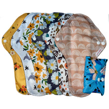 Load image into Gallery viewer, 7 x large reusable sanitary pads in different designs including; floral, birds, daisies, rainbows plus one folded to show how compact they are
