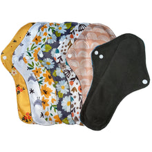 Load image into Gallery viewer, 7 x large reusable sanitary pads in different designs including; floral, birds, daisies, rainbows plus one facing the other way to show the black bamboo absorbent layer.
