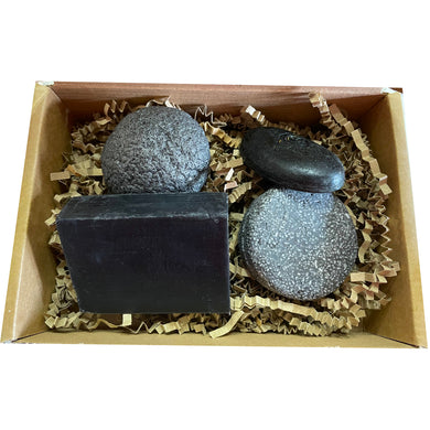 the charcoal one gift set, bundle containing konjac sponge, activated charcoal soap bar, black beauty solid conditioner bar, bamboozle bamboo charcoal solid shampoo bar