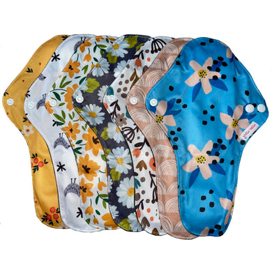 7 x large reusable sanitary pads in different designs including; floral, birds, daisies, rainbows