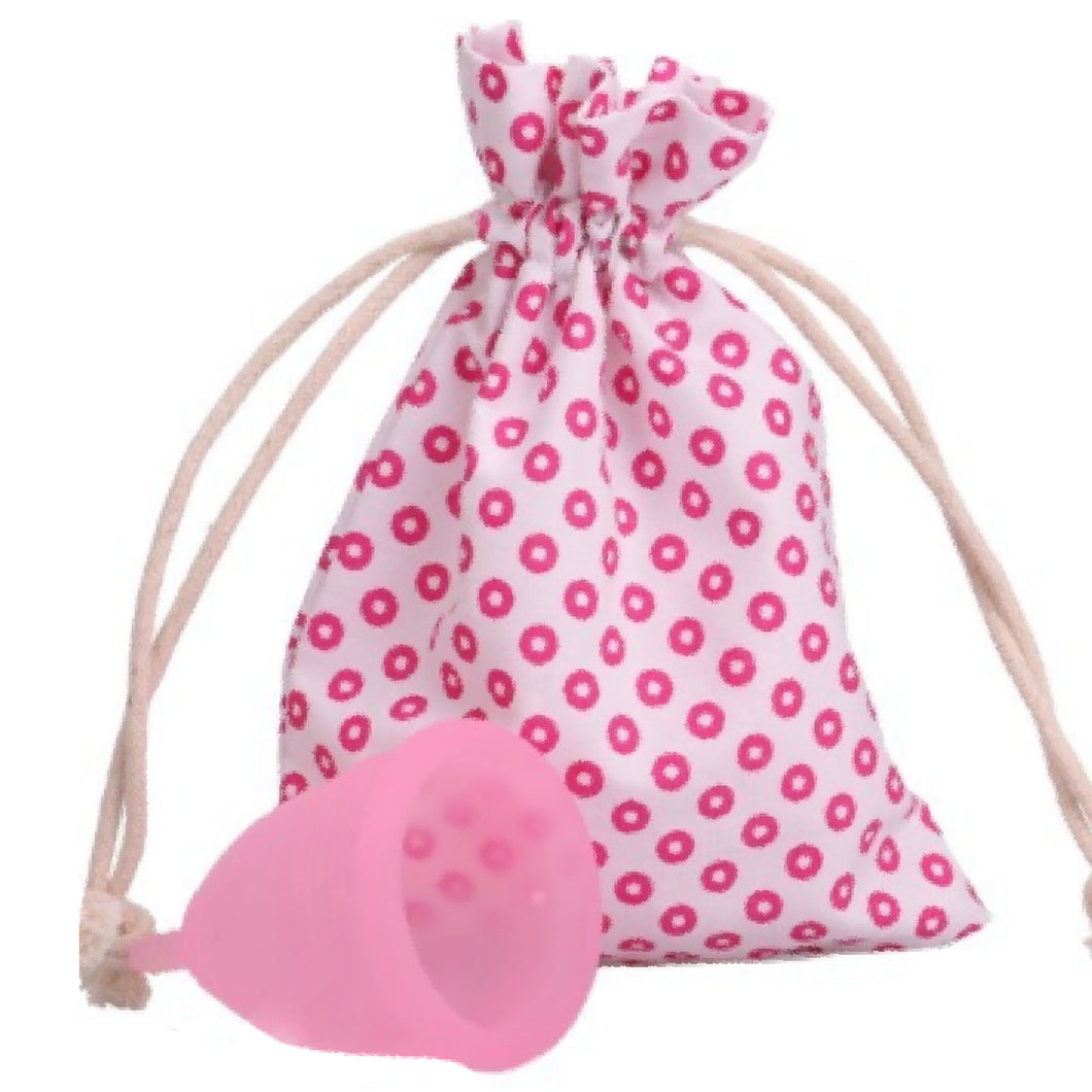 pink and white dotted cotton drawstring bag with pink menstrual cup sitting in front