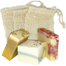 Load image into Gallery viewer, three plastic free natural eco ramie soap savers with three soaps stood in front.
