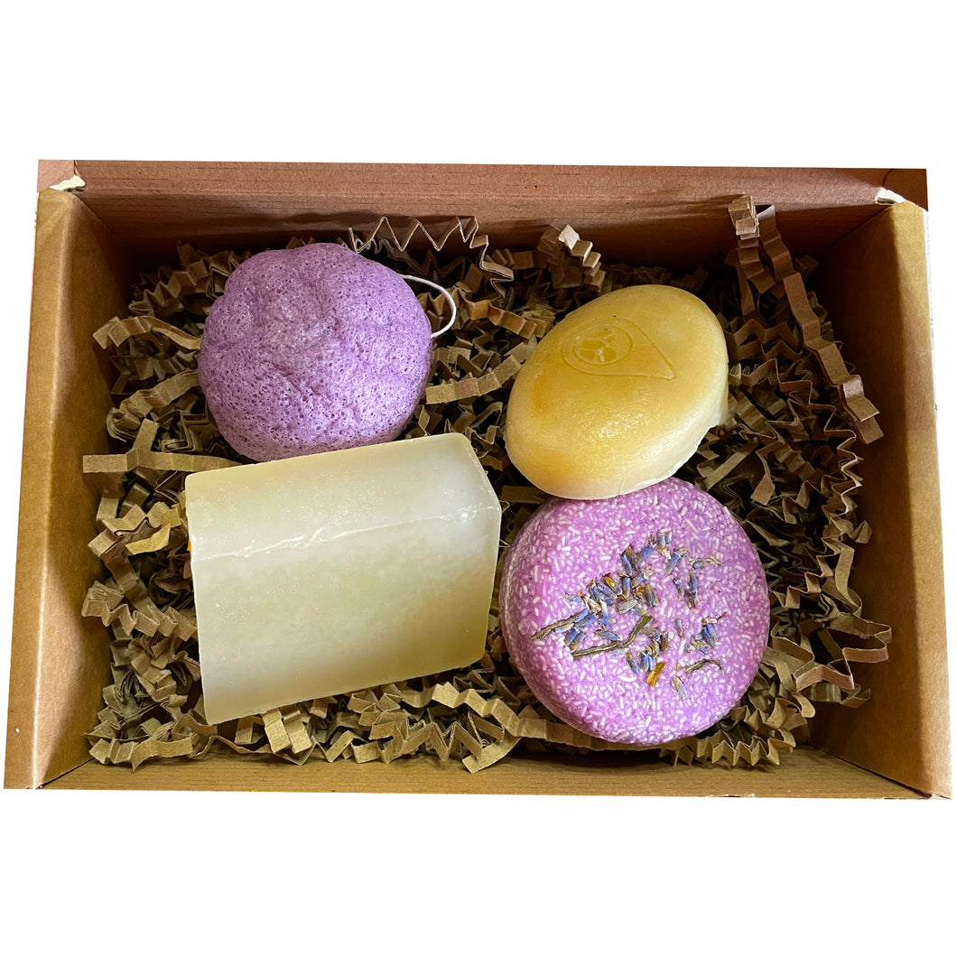 the relaxed one gift set, bundle containing konjac sponge, sleepy baby soap bar, razzle dazzle solid conditioner bar, hypnotic lavender solid shampoo bar