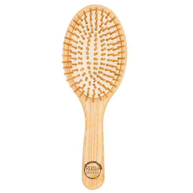 bamboo round hair brush with natural rubber. rush organics logo at the bottom on the handle.