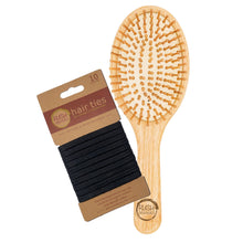 Load image into Gallery viewer, bamboo round hair brush with natural rubber. rush organics logo at the bottom on the handle. 10 x plastic free black hair ties on cardboard holder.
