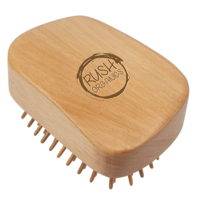 bamboo detangling hair brush tangle teaser with natural rubber. rush organics logo at the bottom on the handle. 