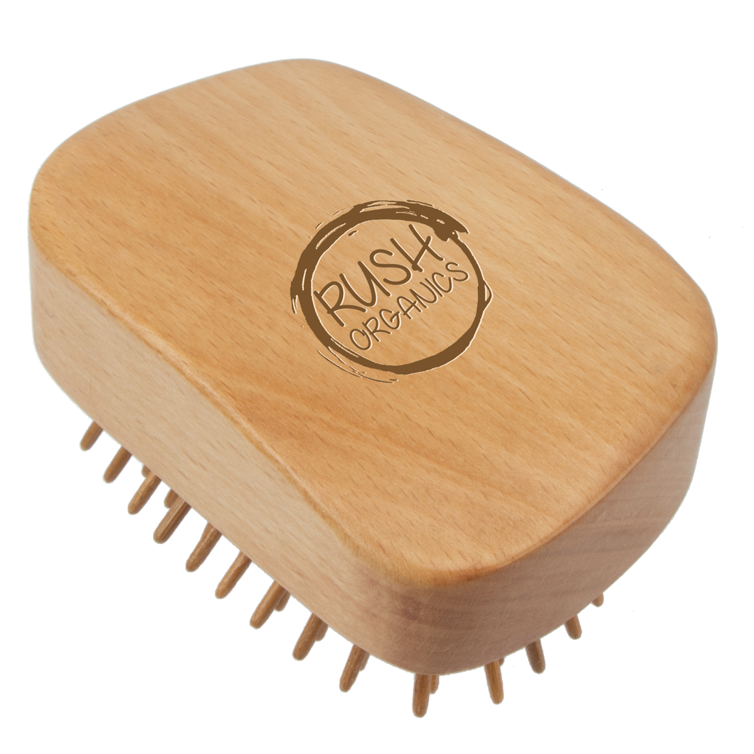 bamboo detangling hair brush tangle teaser with natural rubber. rush organics logo at the bottom on the handle. 